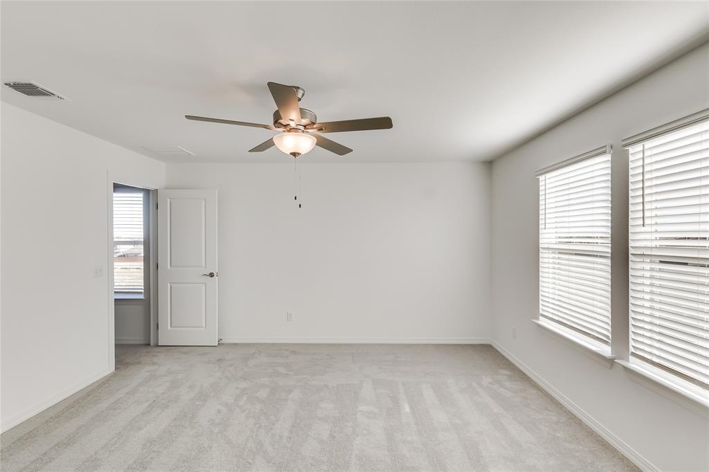 109 Bridge Deck Loop Kyle, TX 78640 - Photo 21 of 40 Empty room with light colored carpet and ceiling fan
