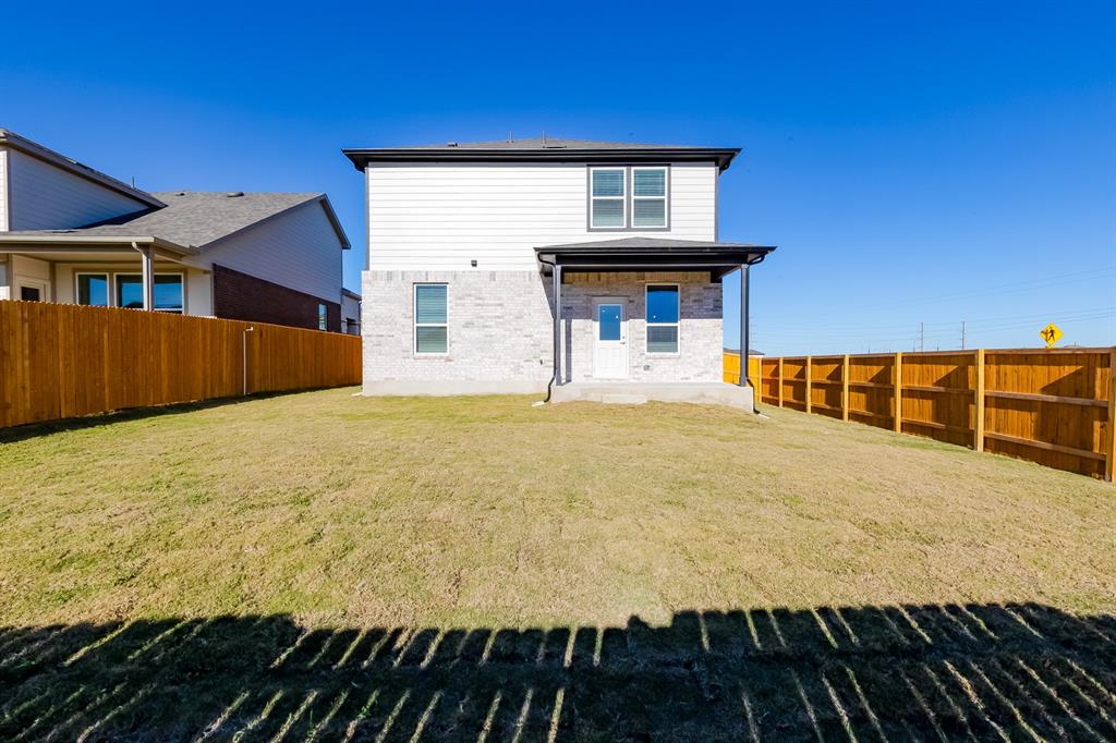 109 Bridge Deck Loop Kyle, TX 78640 - Photo 29 of 40 Rear view of property featuring a fenced backyard, a patio, and brick siding