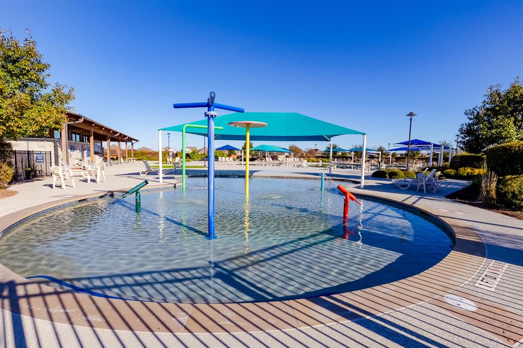 109 Bridge Deck Loop Kyle, TX 78640 - Photo 35 of 40 Community pool featuring a water play area and a patio