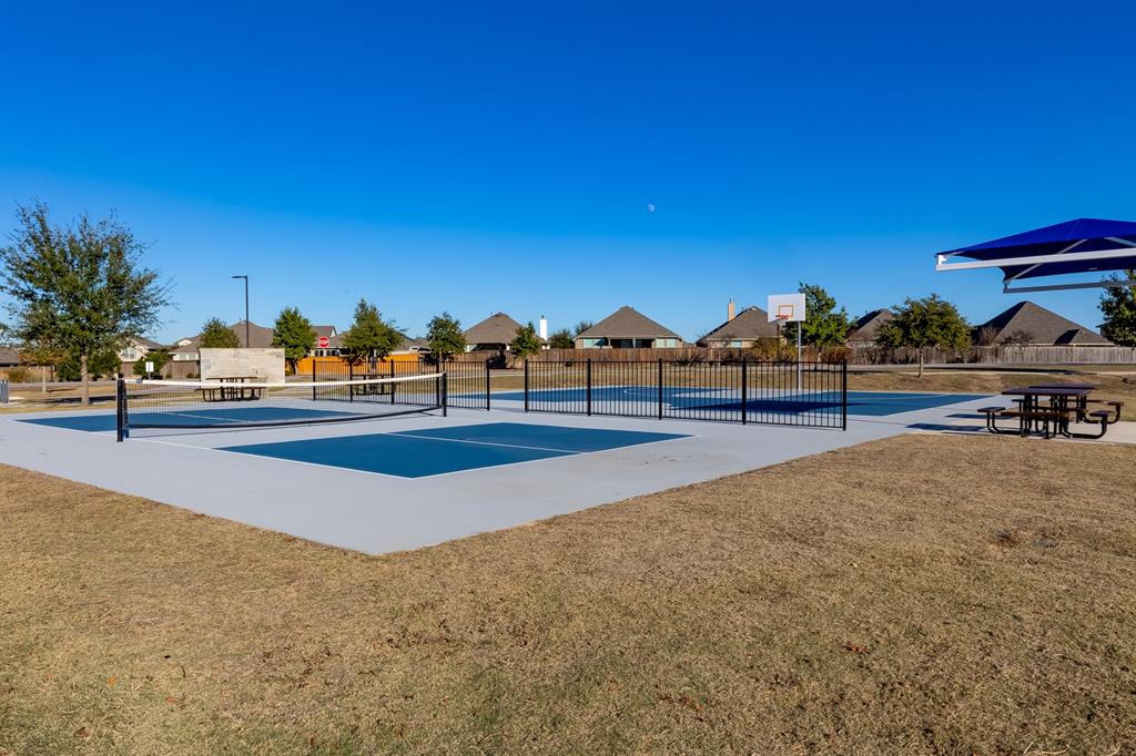 109 Bridge Deck Loop Kyle, TX 78640 - Photo 37 of 40 View of sport court with a residential view, a patio, and a tennis court
