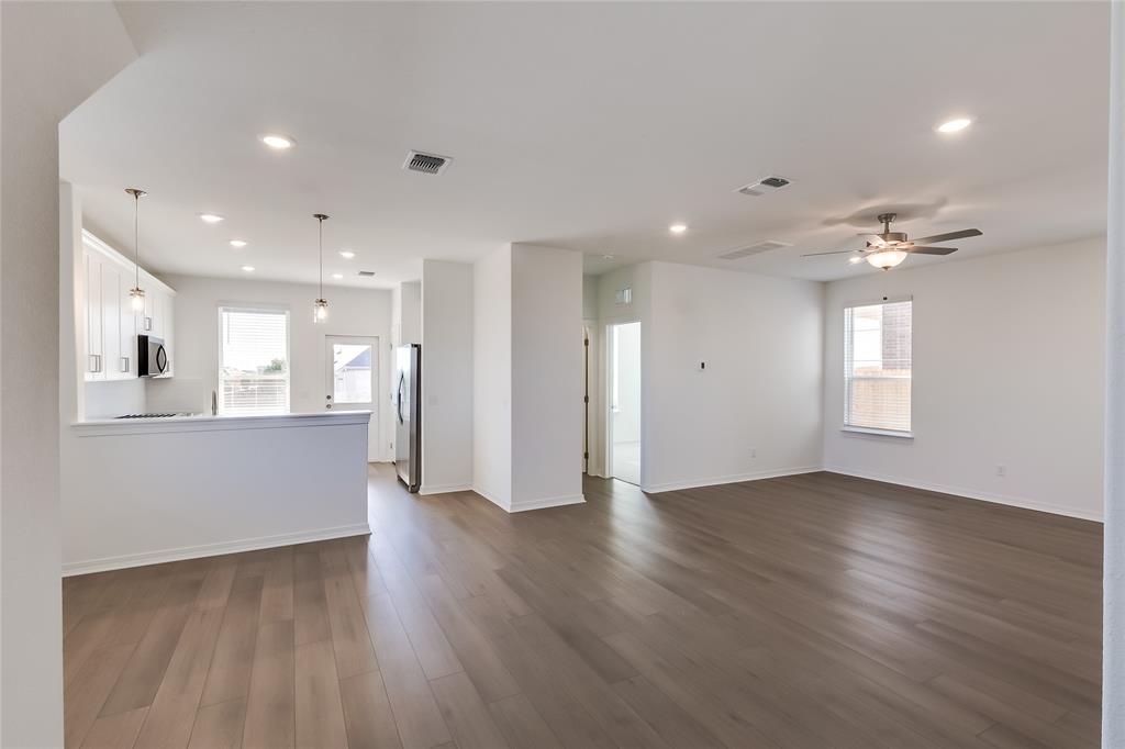 109 Bridge Deck Loop Kyle, TX 78640 - Photo 5 of 40 Unfurnished living room featuring dark wood-type flooring, recessed lighting, and a ceiling fan