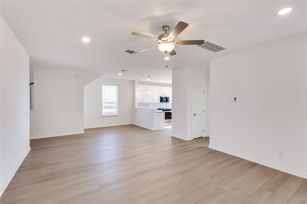 109 Bridge Deck Loop Kyle, TX 78640 - Photo 7 of 40 Unfurnished living room with recessed lighting, light wood-style flooring, and ceiling fan
