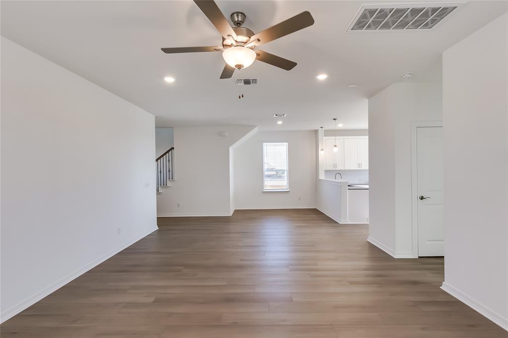 109 Bridge Deck Loop Kyle, TX 78640 - Photo 8 of 40 Unfurnished living room featuring light wood-style flooring, recessed lighting, ceiling fan, and stairs