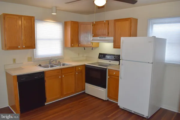 a kitchen with a refrigerator sink and cabinets