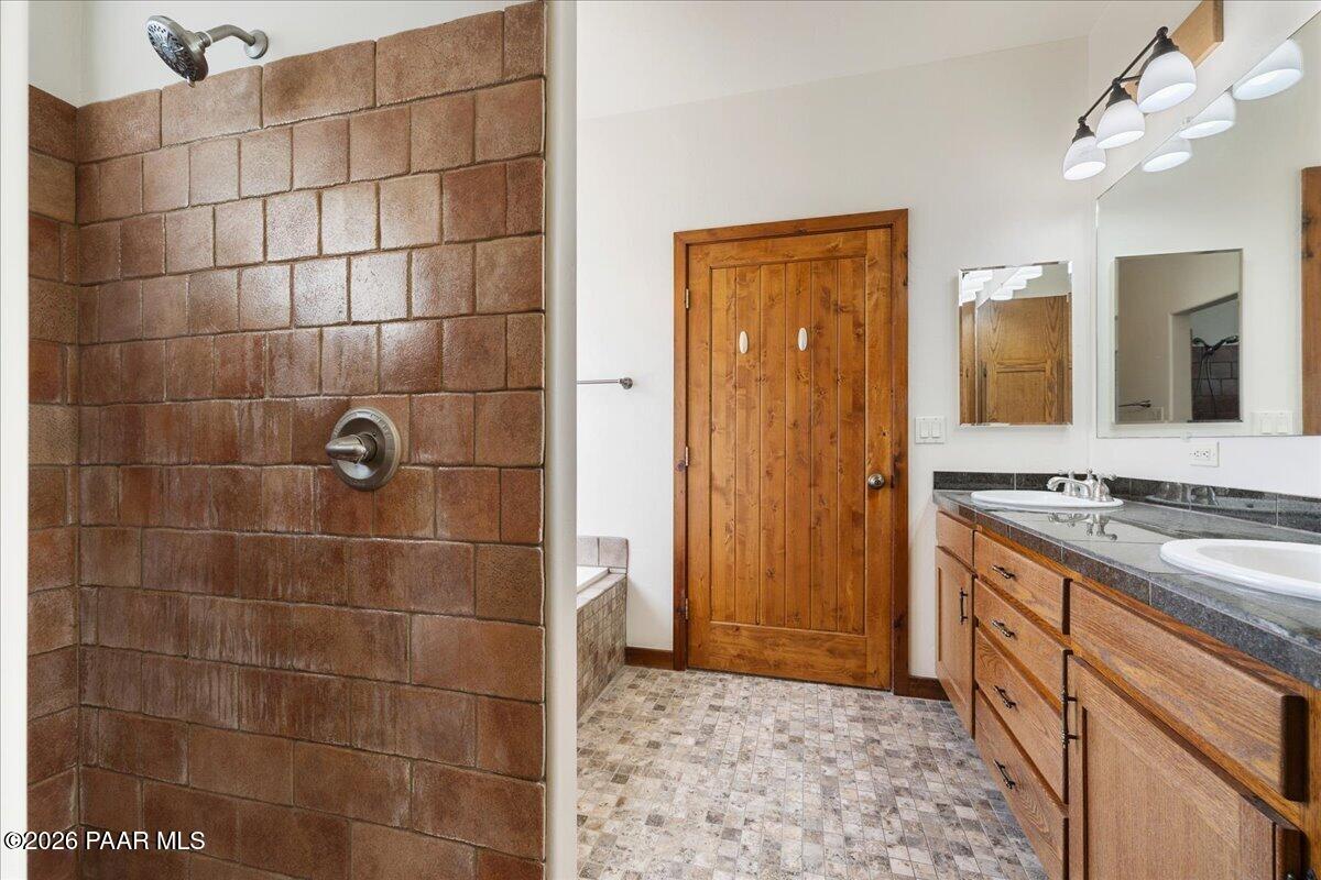 4755 East Lynn Court Lake Montezuma, AZ 86335 - Photo 17 of 36 a bathroom with a granite countertop sink a toilet and shower