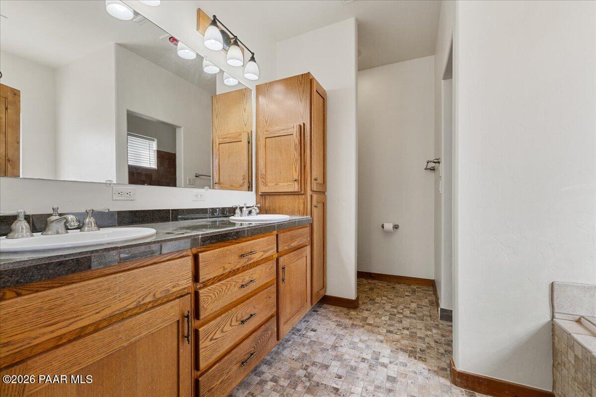4755 East Lynn Court Lake Montezuma, AZ 86335 - Photo 19 of 36 a bathroom with a sink a vanity and a mirror