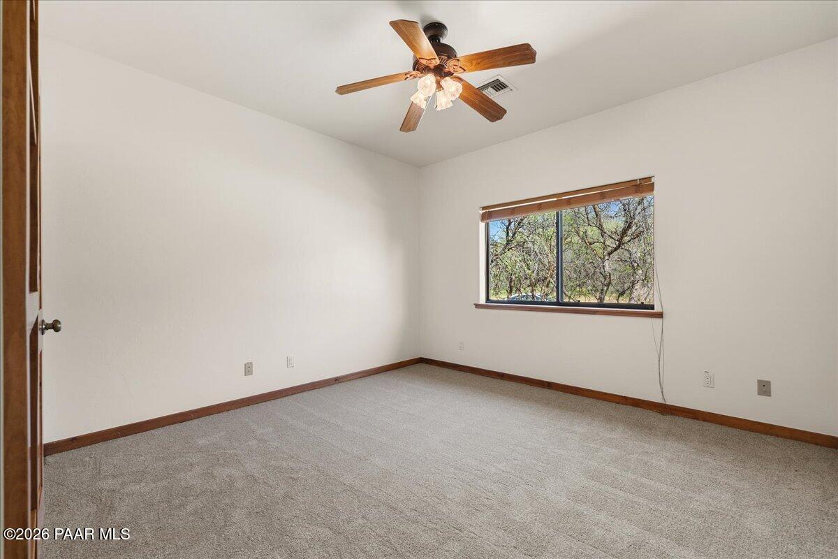 4755 East Lynn Court Lake Montezuma, AZ 86335 - Photo 23 of 36 an empty room with a window and a ceiling fan