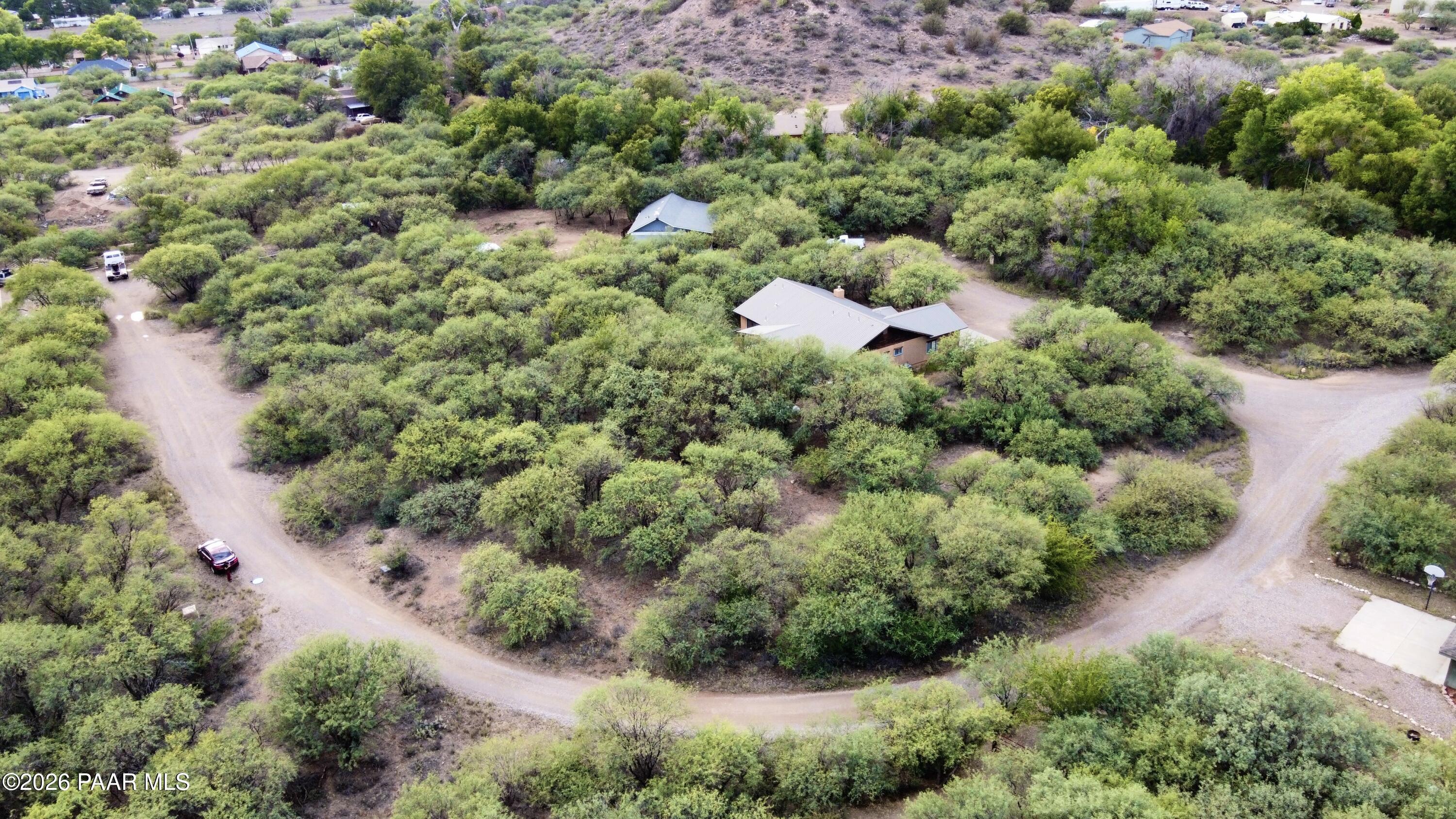4755 East Lynn Court Lake Montezuma, AZ 86335 - Photo 28 of 36 an aerial view of residential house with outdoor space and trees in the background