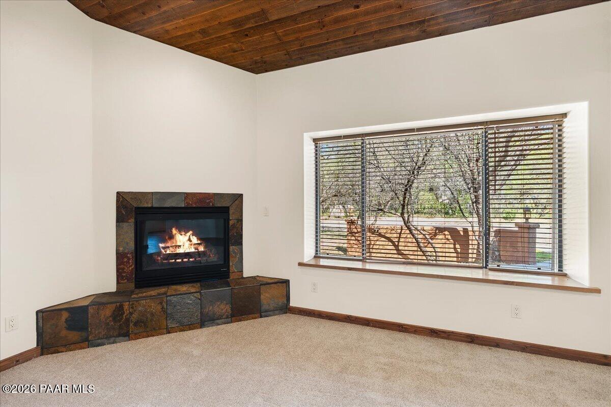 4755 East Lynn Court Lake Montezuma, AZ 86335 - Photo 7 of 36 a living room with furniture a flat screen tv and a fireplace