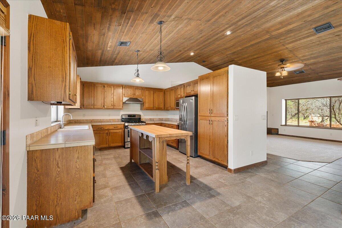 4755 East Lynn Court Lake Montezuma, AZ 86335 - Photo 9 of 36 a kitchen with refrigerator and cabinets