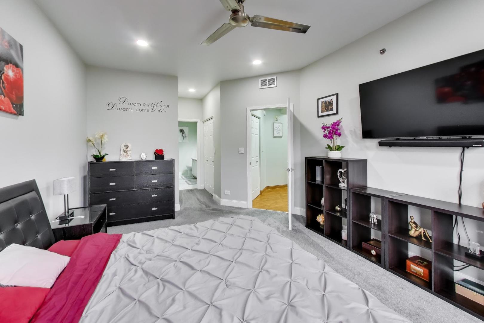 8225 Concord Lane, Unit I Justice, IL 60458 - Photo 15 of 28 a bedroom with a bed and a flat screen tv