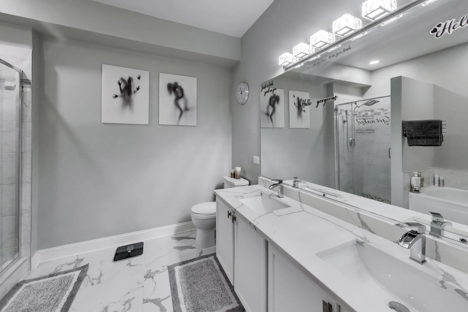 8225 Concord Lane, Unit I Justice, IL 60458 - Photo 16 of 28 a bathroom with a double vanity sink mirror and toilet