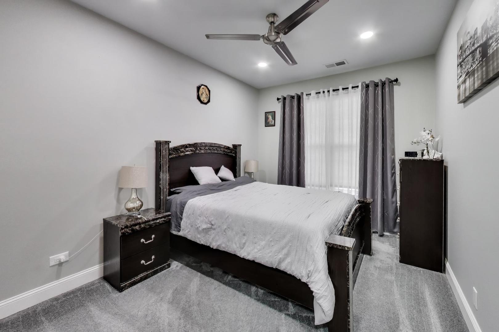 8225 Concord Lane, Unit I Justice, IL 60458 - Photo 18 of 28 a bedroom with a bed and a table