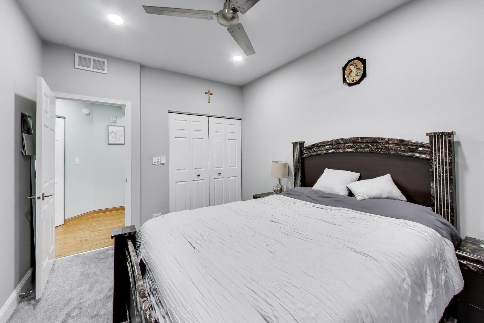 8225 Concord Lane, Unit I Justice, IL 60458 - Photo 19 of 28 a bedroom with a bed and a table