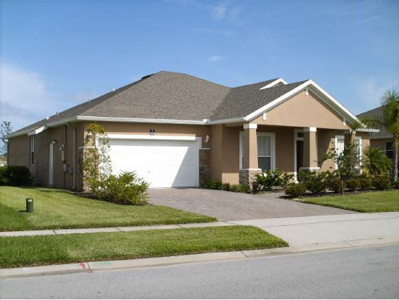 3221 Merrick Avenue Rockledge, FL 32955 - Photo 1 of 12 a front view of a house with a yard and garage