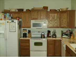 3221 Merrick Avenue Rockledge, FL 32955 - Photo 3 of 12 a kitchen with stainless steel appliances a refrigerator a sink and cabinets