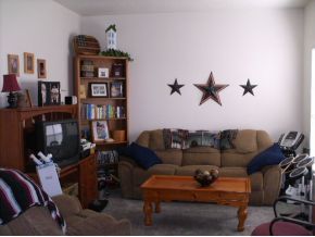3221 Merrick Avenue Rockledge, FL 32955 - Photo 5 of 12 a living room with furniture a ceiling fan and a book shelf