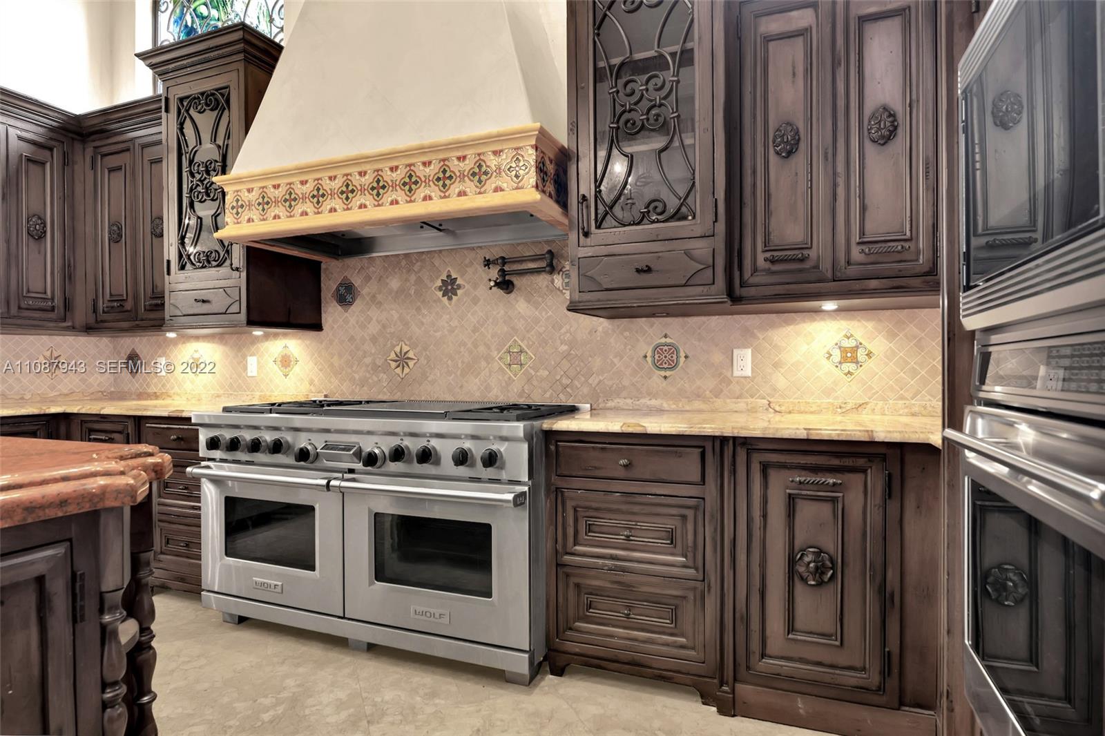 17828 Scarsdale Way Boca Raton, FL 33496 - Photo 50 of 100 a kitchen with stainless steel appliances granite countertop a stove and a microwave