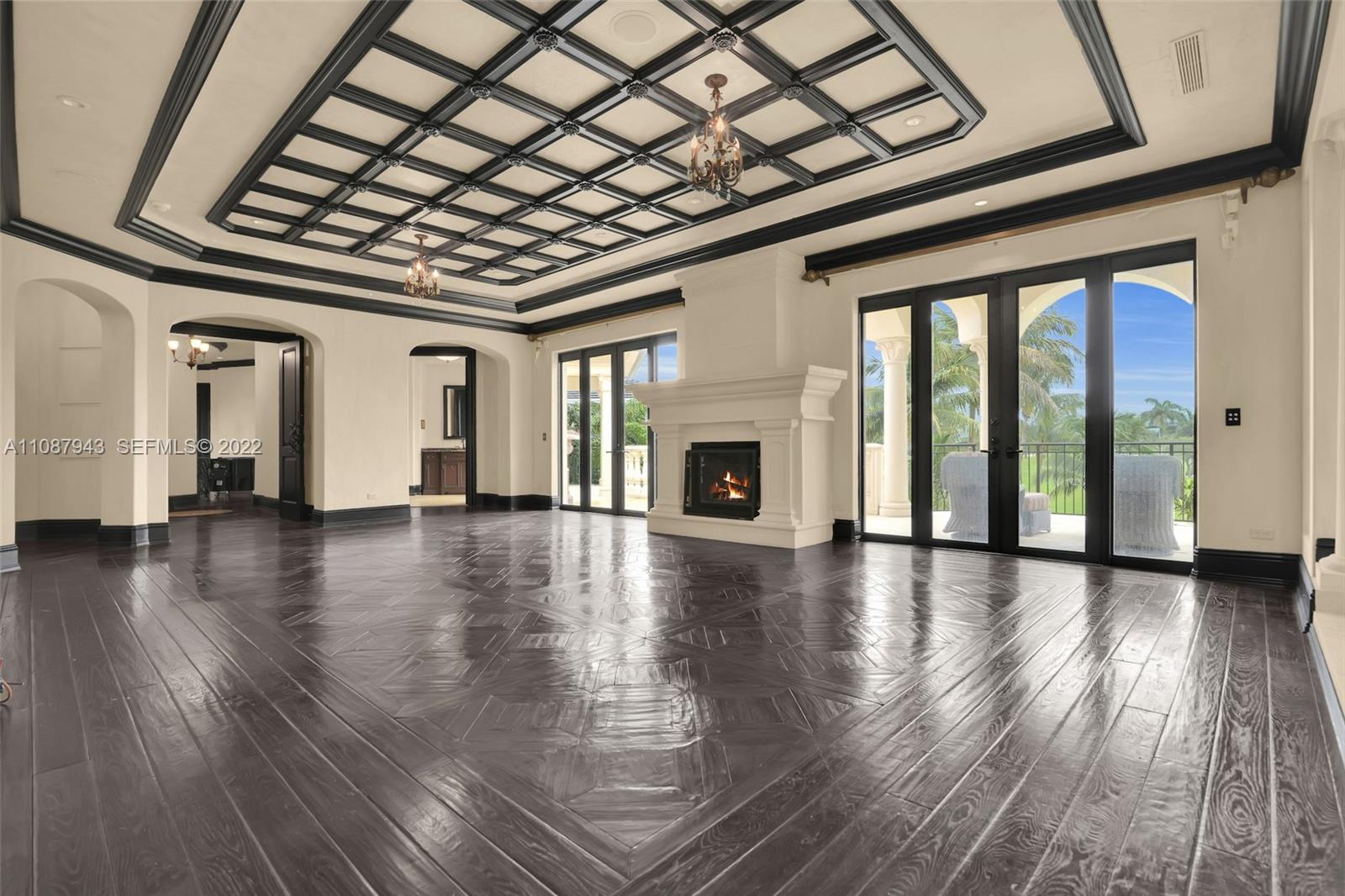 17828 Scarsdale Way Boca Raton, FL 33496 - Photo 57 of 100 a view of an empty room with wooden floor and a fireplace