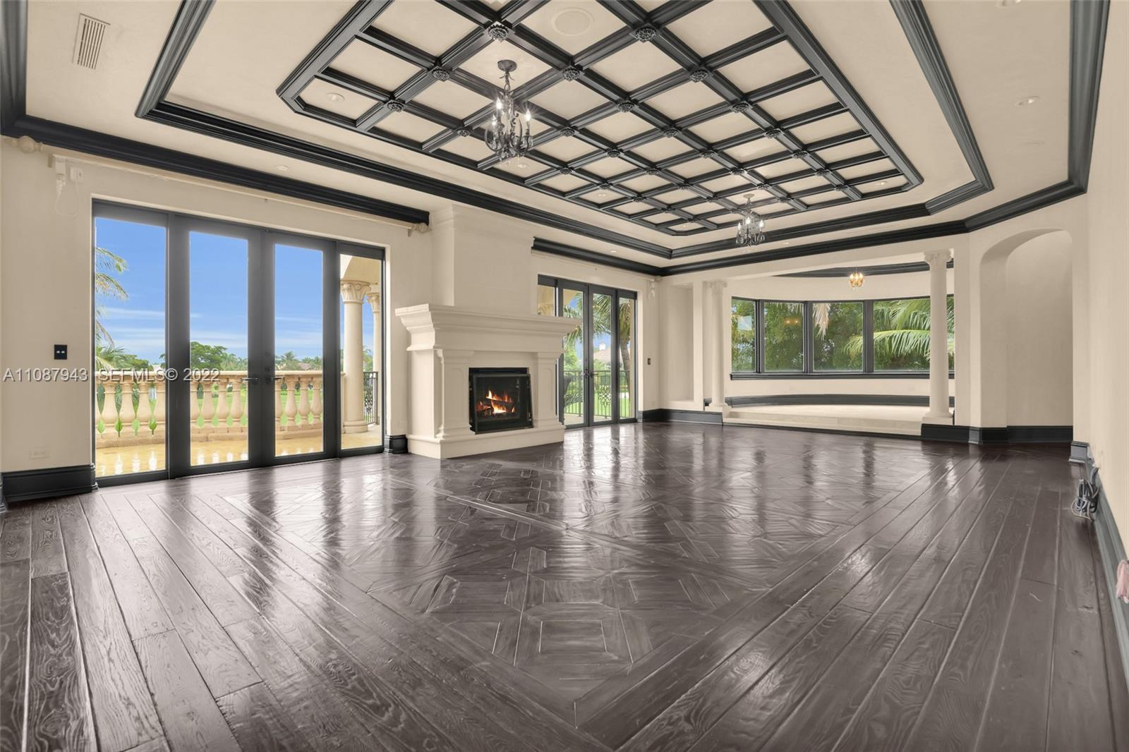 17828 Scarsdale Way Boca Raton, FL 33496 - Photo 58 of 100 a view of empty room with wooden floor and fireplace