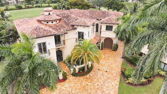 17828 Scarsdale Way Boca Raton, FL 33496 - Photo 6 of 100 a view of a white house with a big yard and potted plants
