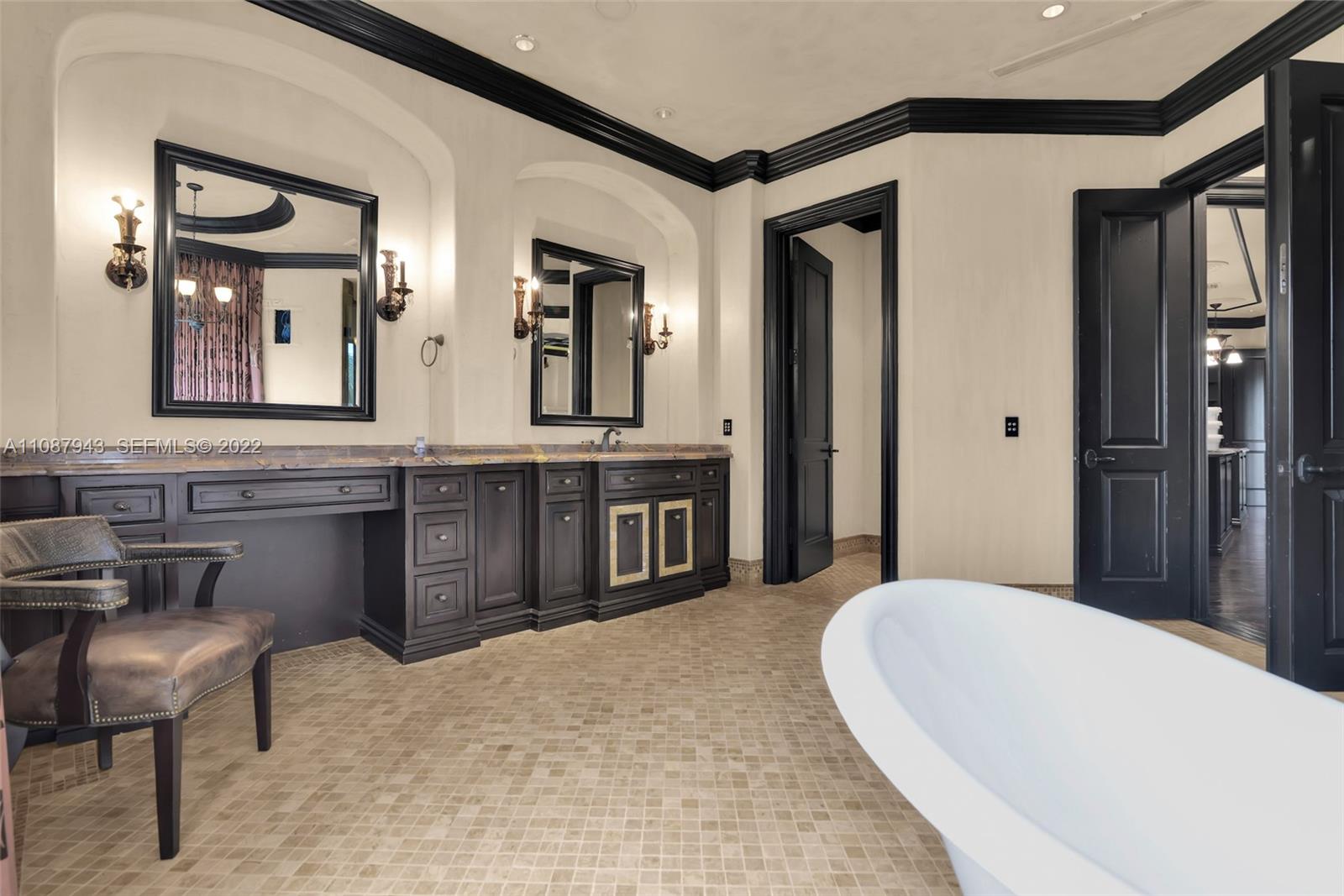 17828 Scarsdale Way Boca Raton, FL 33496 - Photo 68 of 100 a spacious bathroom with a double vanity sink and a mirror