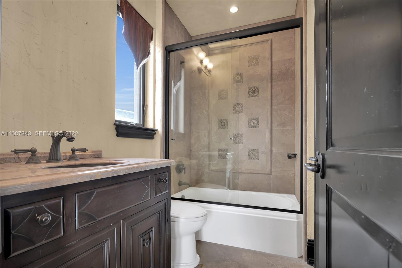 17828 Scarsdale Way Boca Raton, FL 33496 - Photo 73 of 100 a bathroom with a shower sink vanity and mirror