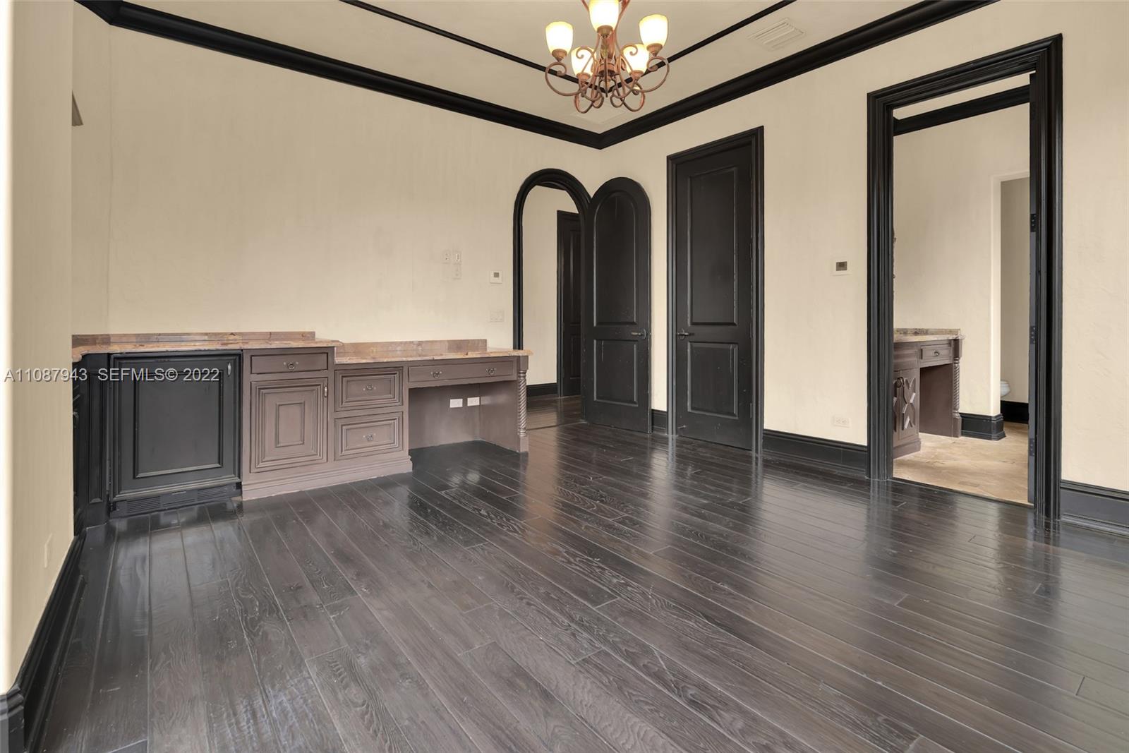 17828 Scarsdale Way Boca Raton, FL 33496 - Photo 74 of 100 a view of a hallway with wooden floor and chandelier