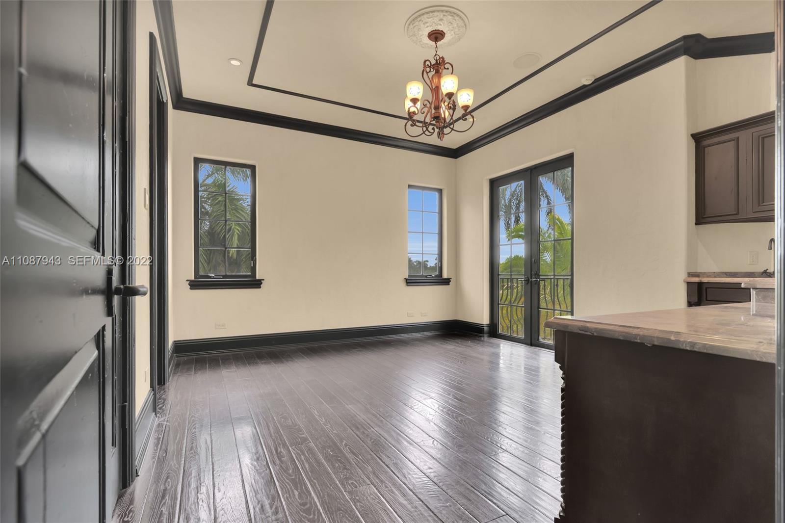 17828 Scarsdale Way Boca Raton, FL 33496 - Photo 75 of 100 a view of an empty room with wooden floor and a window