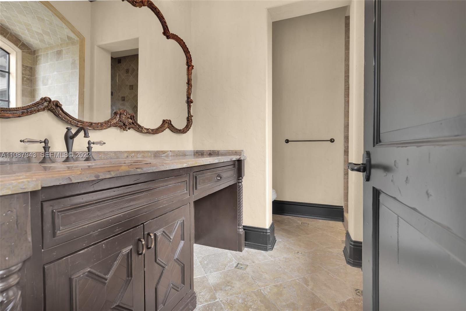 17828 Scarsdale Way Boca Raton, FL 33496 - Photo 76 of 100 a bathroom with a granite countertop sink a mirror and a vanity