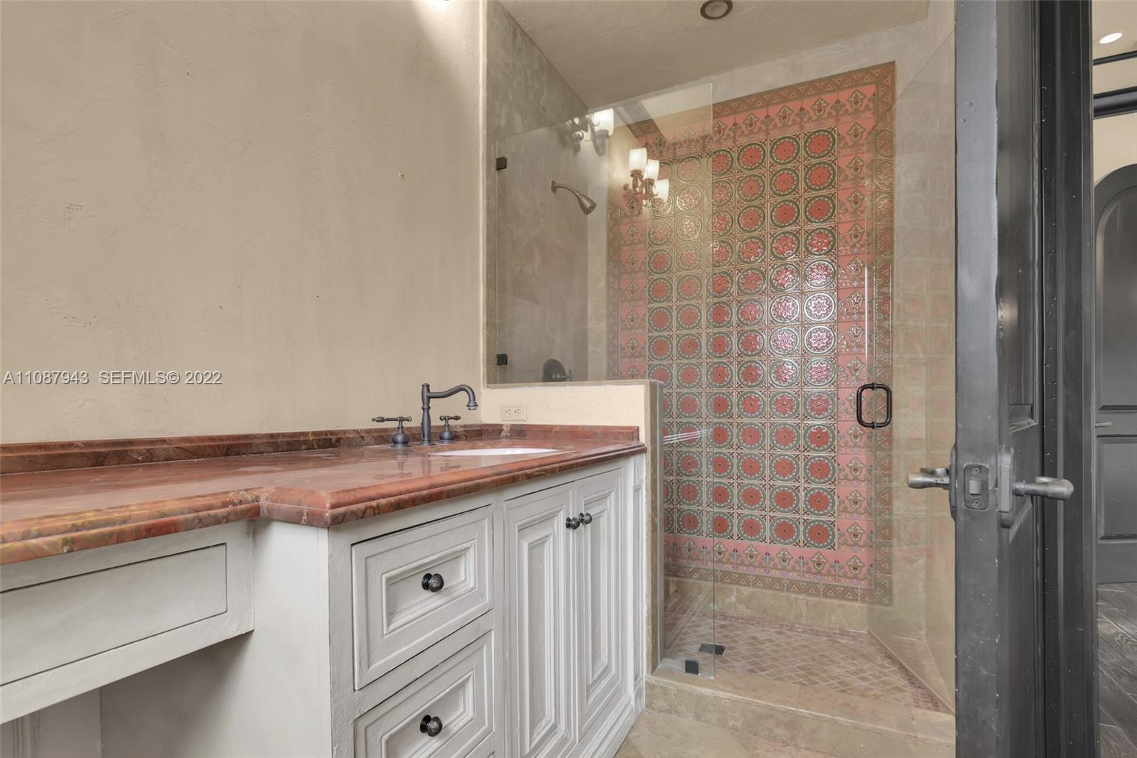 17828 Scarsdale Way Boca Raton, FL 33496 - Photo 83 of 100 a bathroom with a granite countertop sink a shower and a mirror