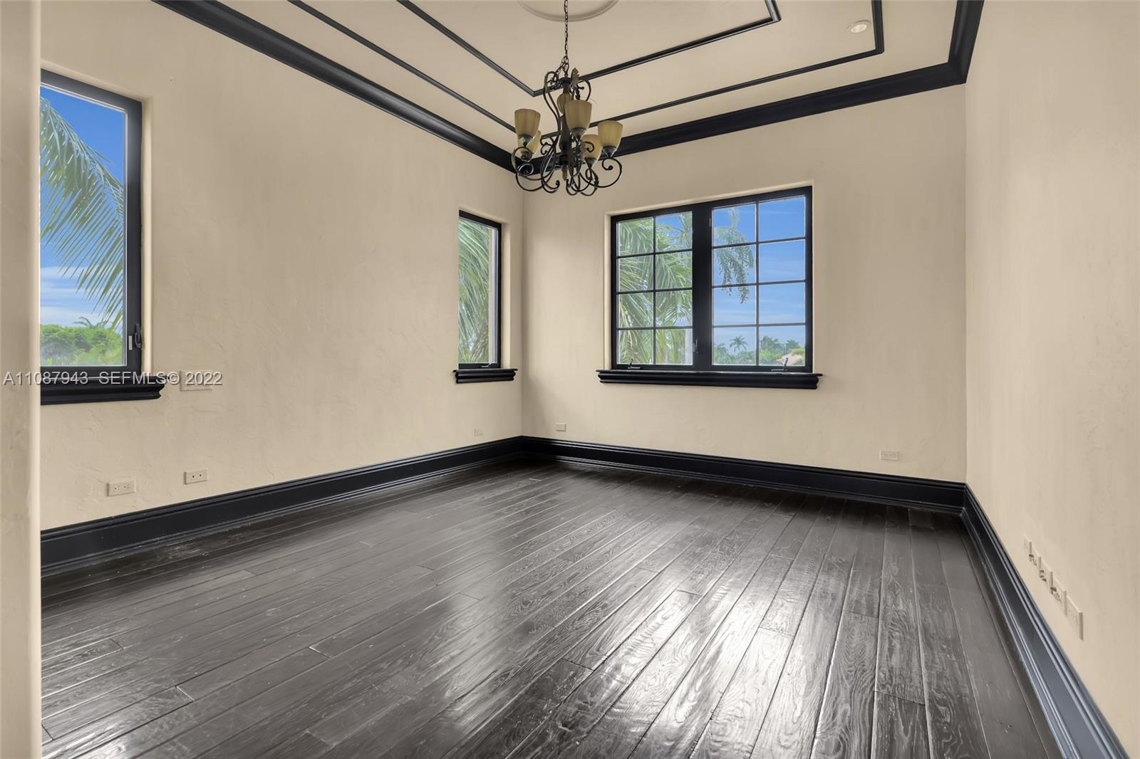 17828 Scarsdale Way Boca Raton, FL 33496 - Photo 84 of 100 a view of a room with wooden floor a ceiling fan and windows