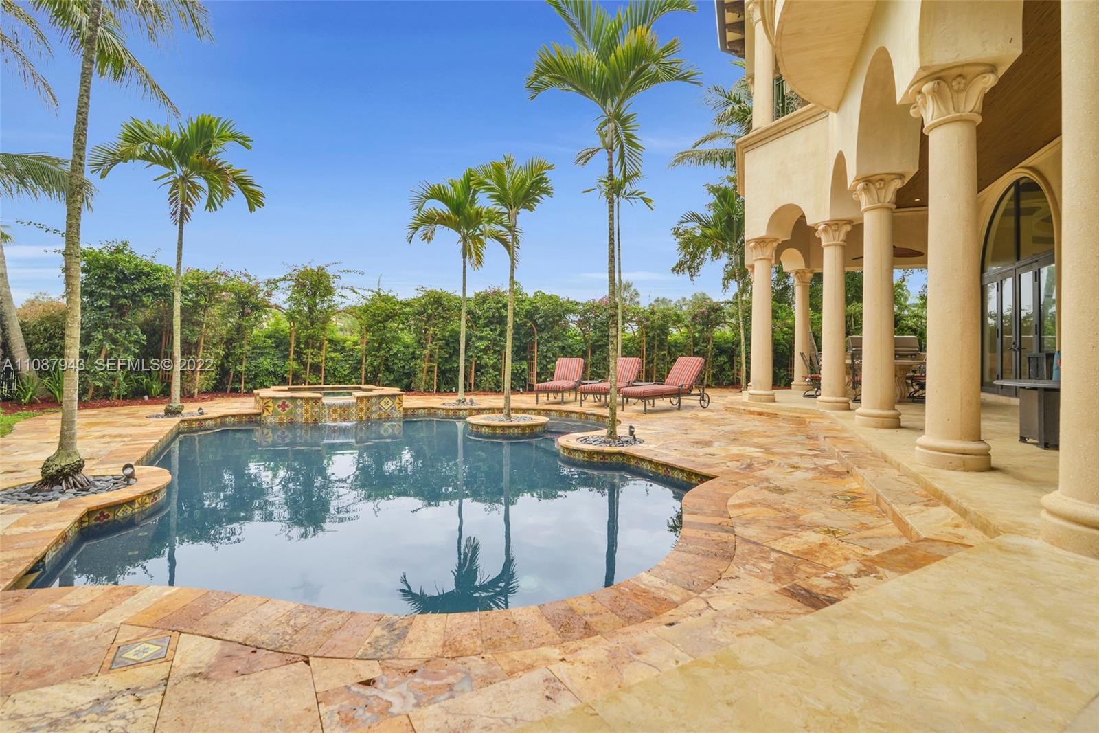 17828 Scarsdale Way Boca Raton, FL 33496 - Photo 93 of 100 a view of swimming pool with a lounge chair and palm trees