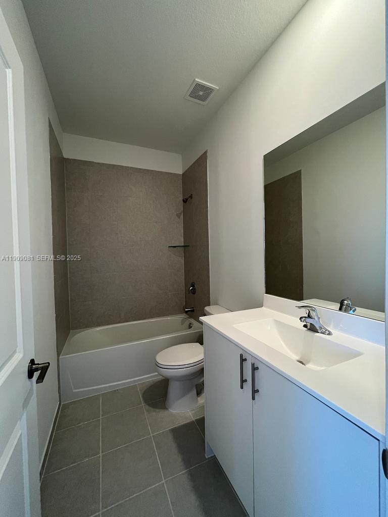 28660 Southwest 134th Court, Unit 28660 Homestead, FL 33033 - Photo 11 of 12 a bathroom with a sink a toilet and shower