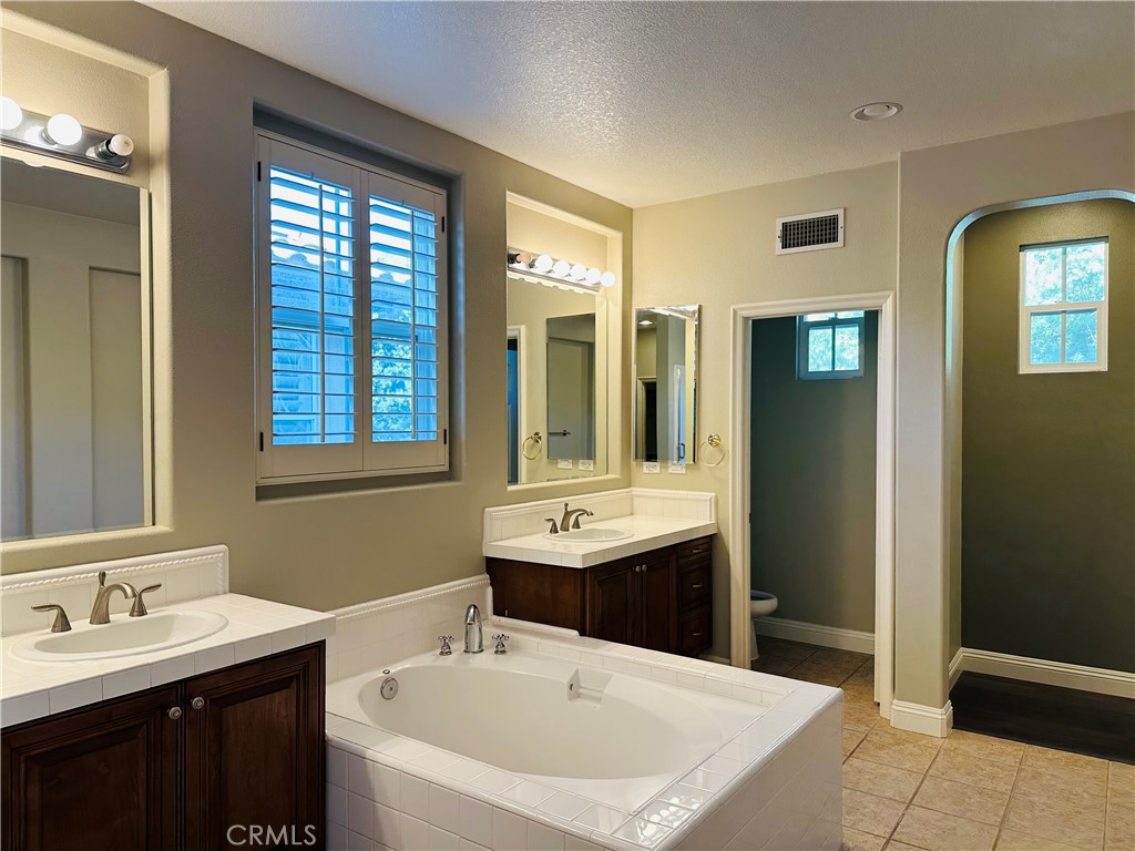 6 Carpenteria Irvine, CA 92602 - Photo 11 of 15 a bathroom with a sink and a mirror