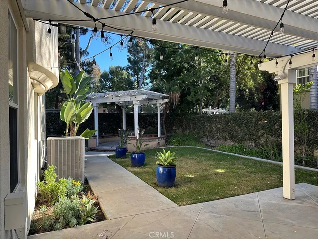 a view of a chair and table in patio with a backyard