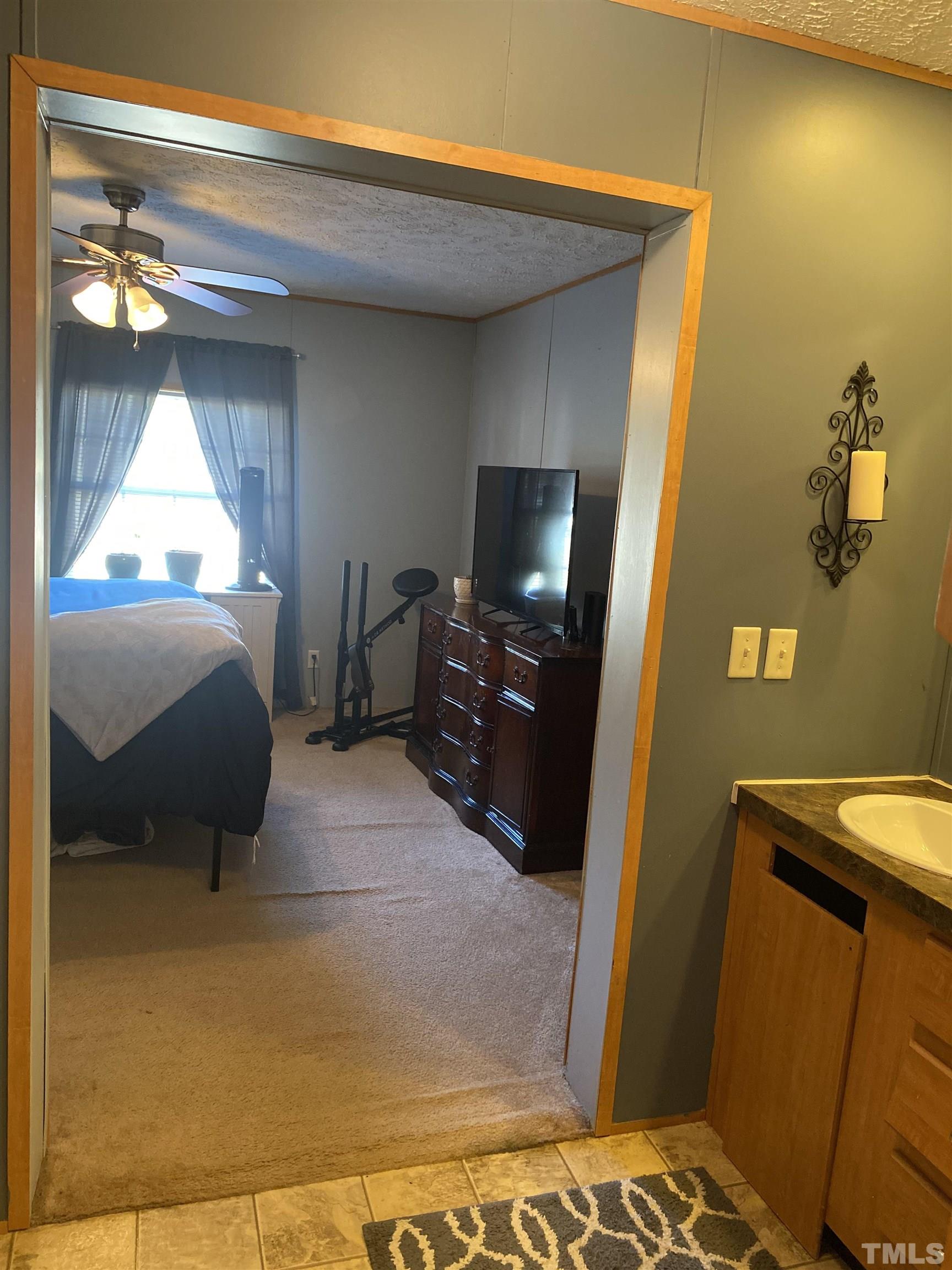 63 Rougemont Road Rougemont, NC 27572 - Photo 12 of 36 a bedroom with a bed and a mirror