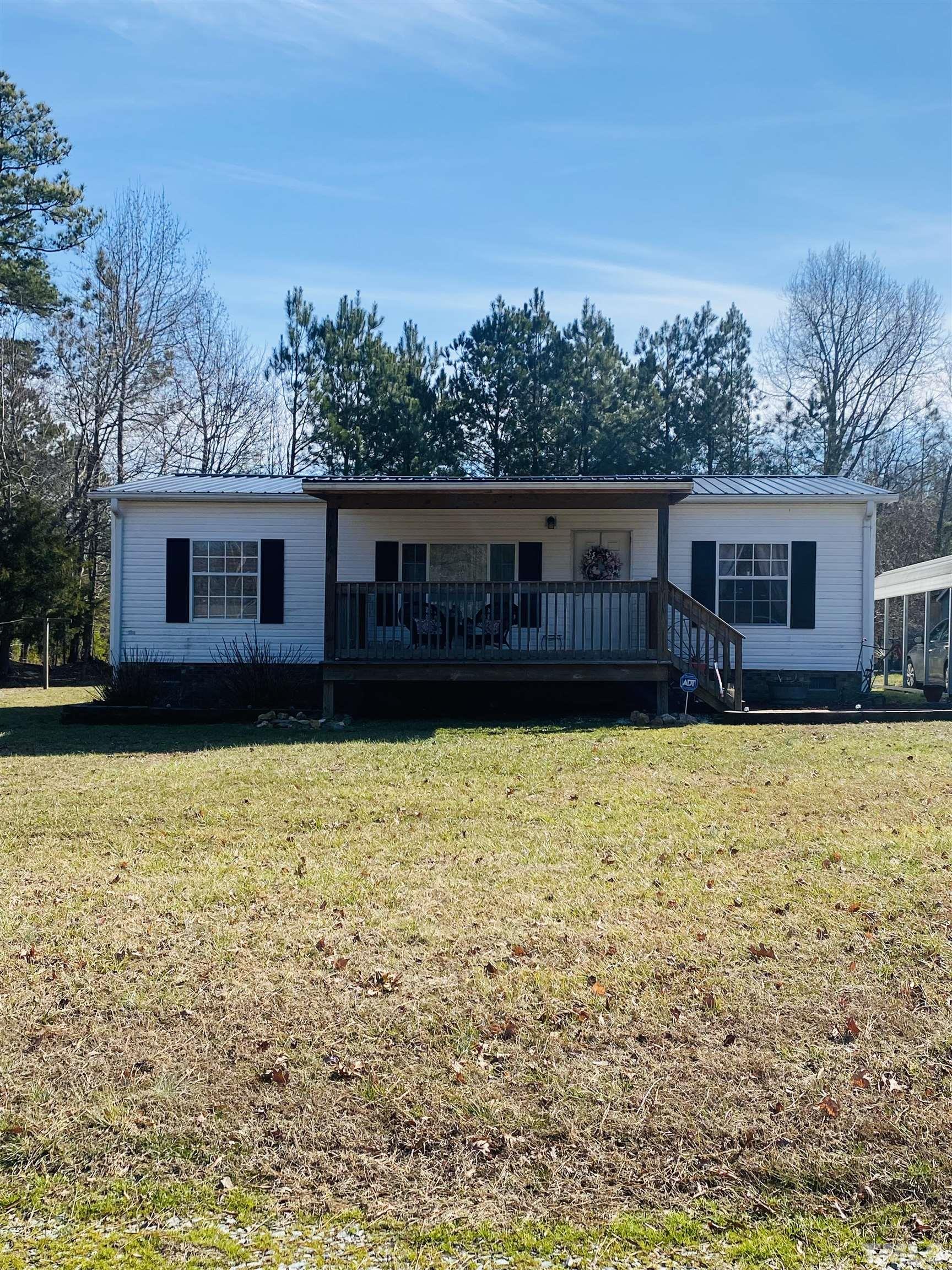 63 Rougemont Road Rougemont, NC 27572 - Photo 2 of 36 a view of a house with wooden floor and a lake view