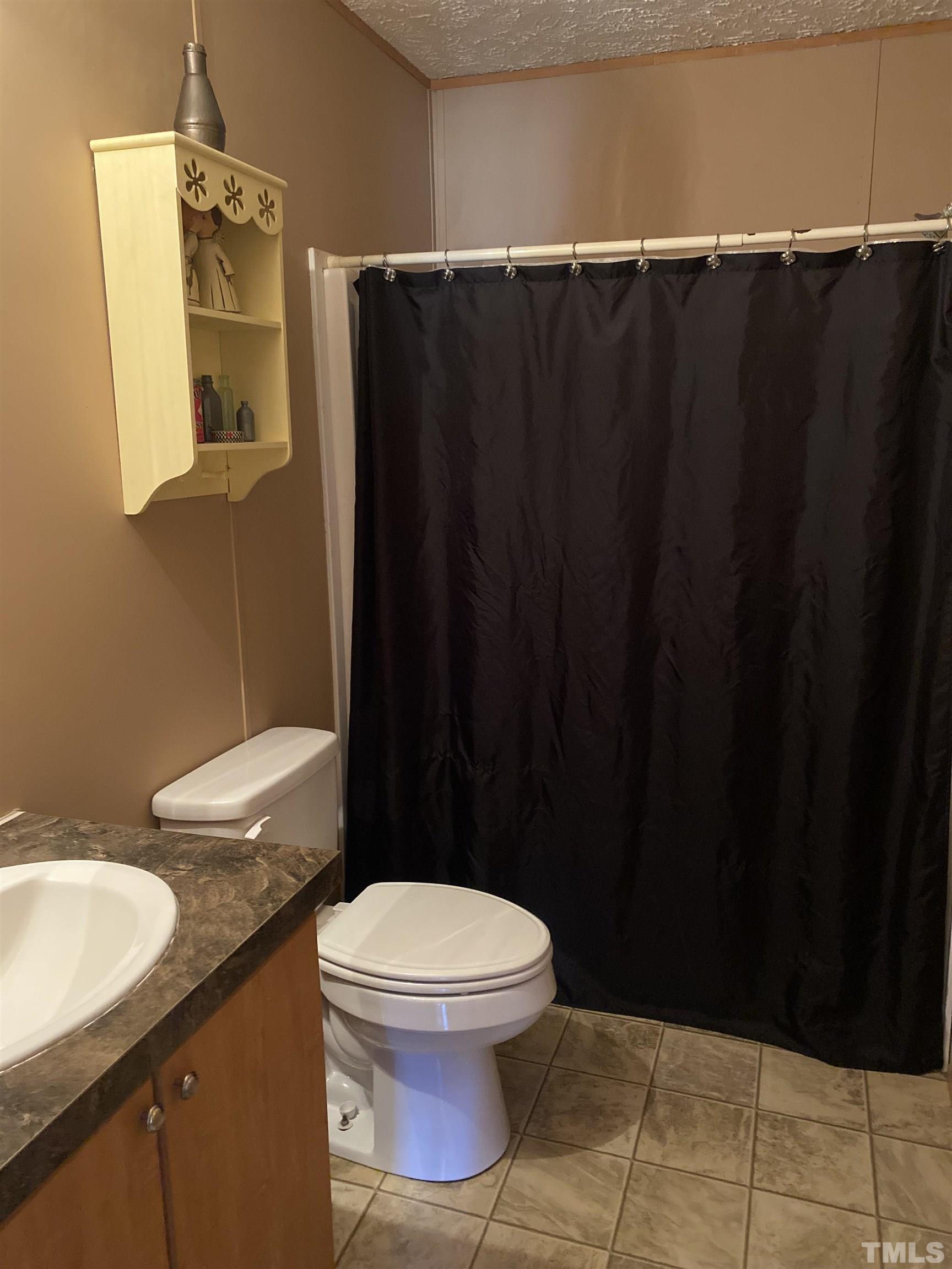 63 Rougemont Road Rougemont, NC 27572 - Photo 21 of 36 a bathroom with a granite countertop toilet and a sink