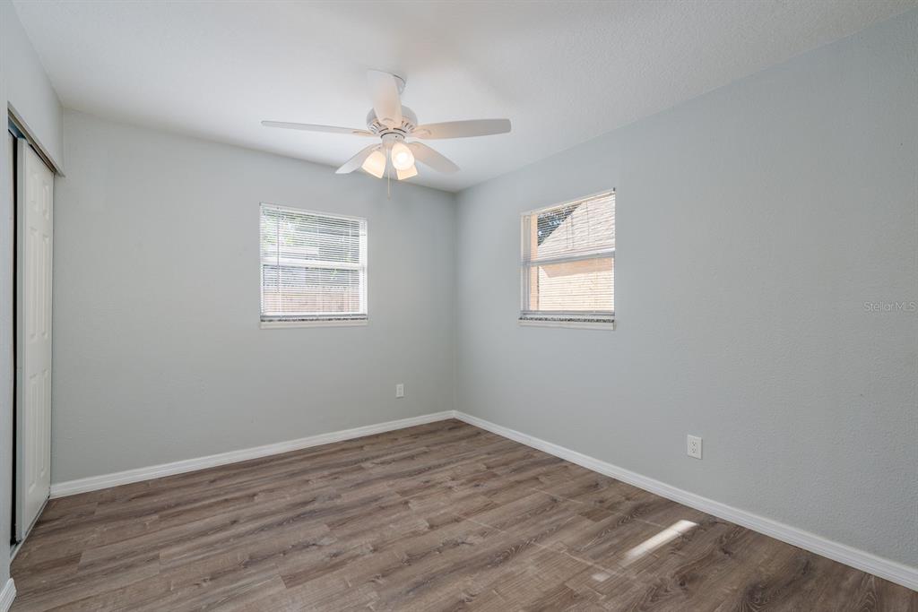 13698 120th Street North Largo, FL 33778 - Photo 16 of 30 an empty room with wooden floor window and ceiling fan