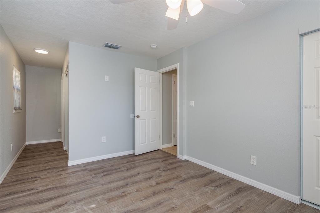 13698 120th Street North Largo, FL 33778 - Photo 17 of 30 a view of an empty room with wooden floor