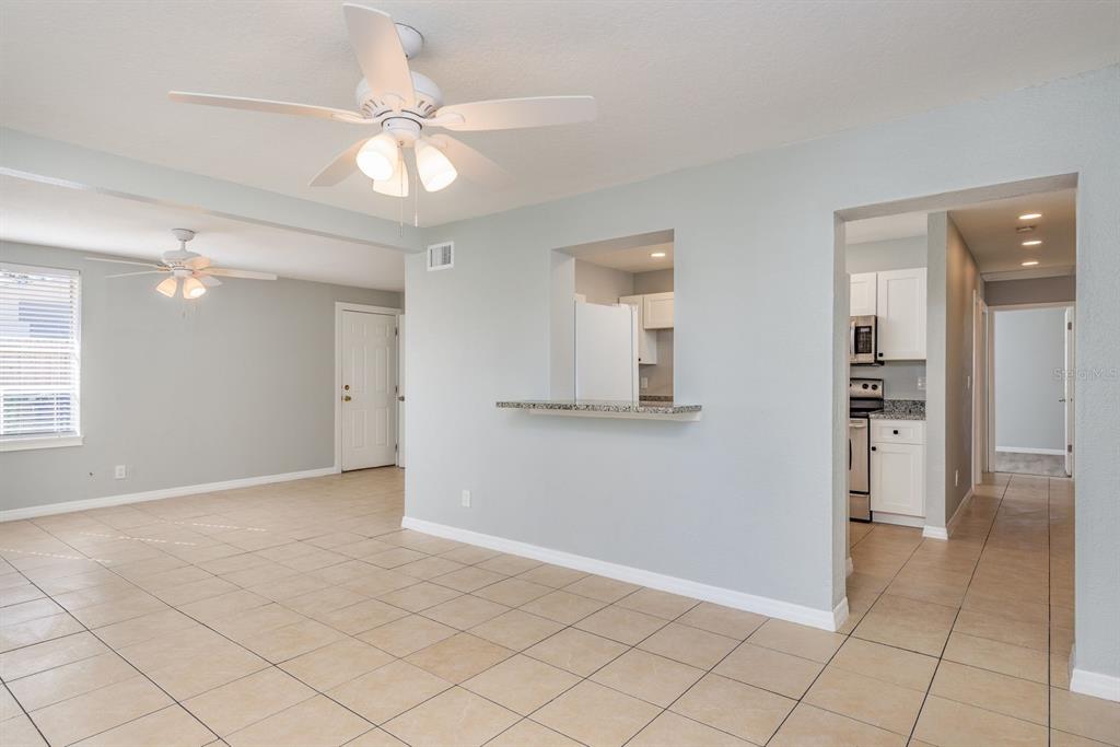 13698 120th Street North Largo, FL 33778 - Photo 7 of 30 an empty room with cabinet and a chandelier fan
