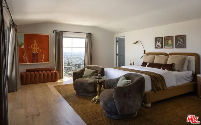 a bedroom with furniture and a window