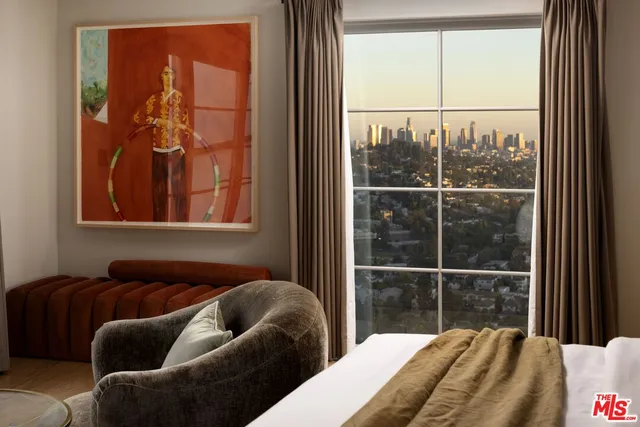 a living room with furniture and a floor to ceiling window