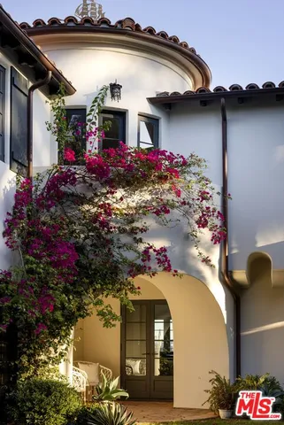 a view of a patio with couches and potted plants