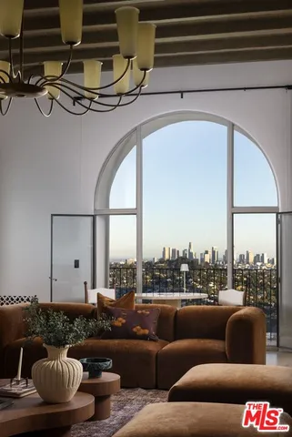 a living room with furniture and a floor to ceiling window
