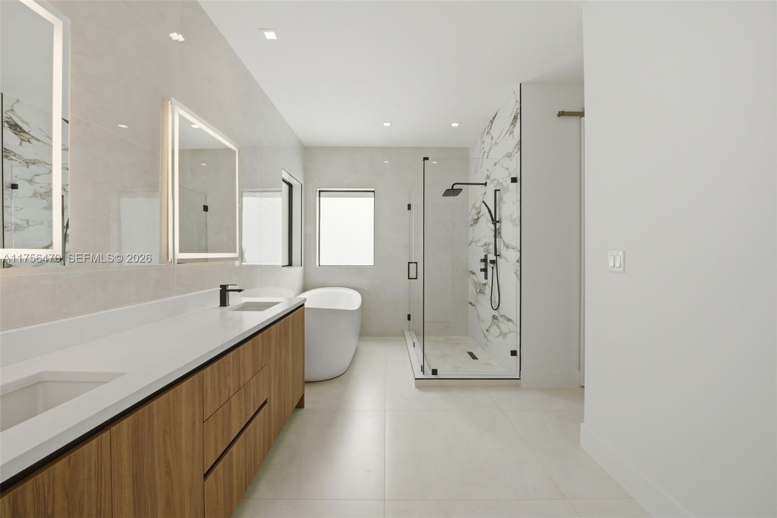 2725 Southwest 65th Avenue Miami, FL 33155 - Photo 24 of 36 a bathroom with a granite countertop sink mirror toilet shower and bathtub