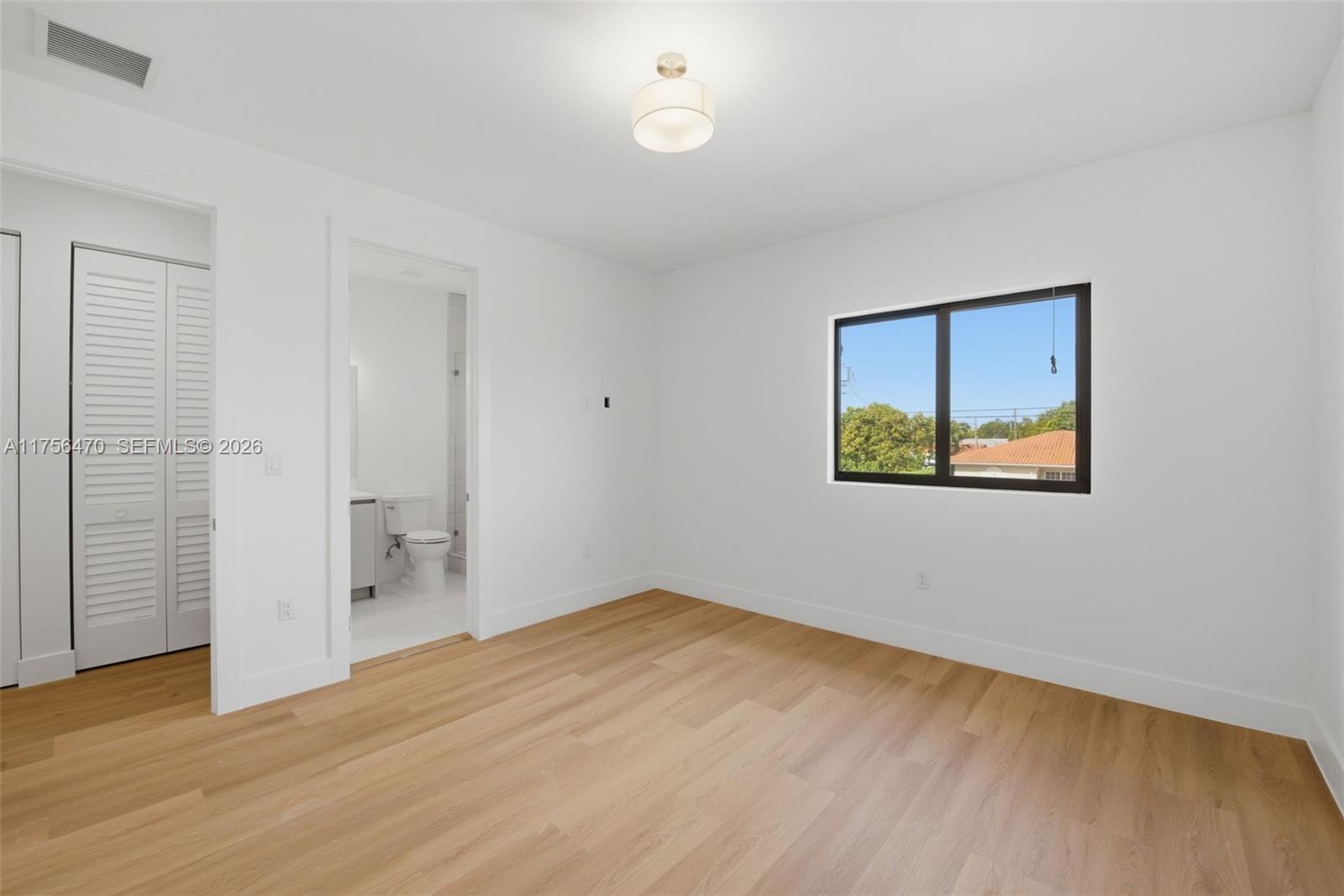 2725 Southwest 65th Avenue Miami, FL 33155 - Photo 27 of 36 an empty room with wooden floor and windows