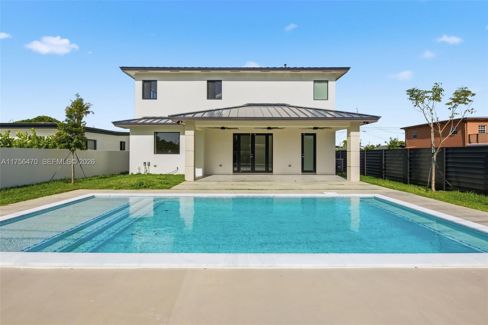 2725 Southwest 65th Avenue Miami, FL 33155 - Photo 31 of 36 a view of a white house with a swimming pool