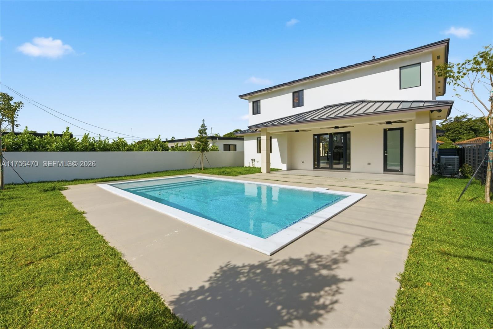 2725 Southwest 65th Avenue Miami, FL 33155 - Photo 34 of 36 a view of a house with swimming pool and a yard
